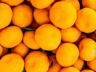 orange mandarin background of fresh juicy tangerines close up, vegan friut conception of citrus