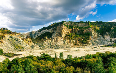 landscape of Plegrean volcano fields in Naples Italy near Pompeii with sulfur yellow caldera duribg eruption of smoke. campi Flegrei and cataclysm of Earthquake