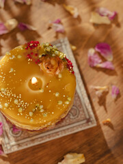 Handmade beeswax candles decorated with flowers and herbs. Beautiful handmade candle. Relaxation atmosphere. Luxurious lifestyle. Selective focus