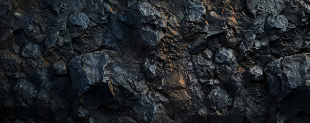 Fototapeta premium A dark, rocky texture background with rugged details and deep shadows, perfect for a bold and intense setting.