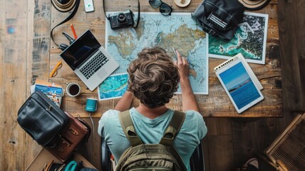 Traveler planning a journey with maps, laptop, and backpack on a wooden table. Travel gear and adventure preparation.