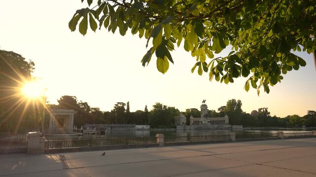 Retiro Park Madrid, Spain Sunrise at the Monument to Alfonso XII. Morning Joggers on Trail. View Through Trees. European Tourist Destination.