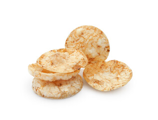 Heap of round brown rice chips, salty crispy snack isolated on white background 