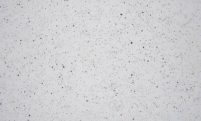 Obraz premium close-up of a white surface with small black dots or specks, resembling a speckled or speckled texture.