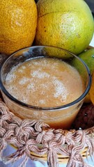 Orange juice and orange in the background 