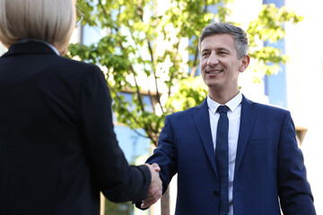 International relations. Diplomats shaking hands during meeting outdoors