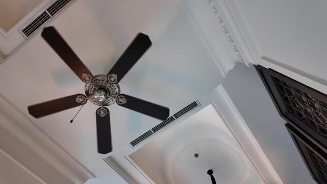 Luxury ceiling fan is running in a hotel lobby. Air conditioners that produce air circulation in hot rooms during the day. 4k video footage - Low Angle.