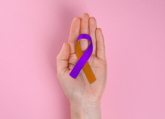 World Psoriasis Day. Woman with orange and orchid ribbon as symbol of support on pink background, top view