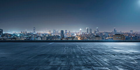 Empty concrete rooftop overlooking a city at twilight