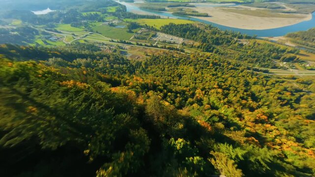 Flight along the mountain range by FPV Drone, Fraser river valley below. Canada