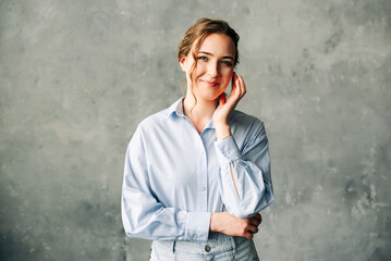 Confident Businesswoman in Modern Office Setting. Stylish young businesswoman stands confidently against, showcasing professionalism and elegance. Ideal for corporate and business-related themes