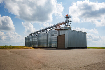 silos on agro-industrial complex with seed cleaning and drying line for grain storage. Granary elevator