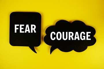 Courage vs Fear text on speech bubble top view on yellow background