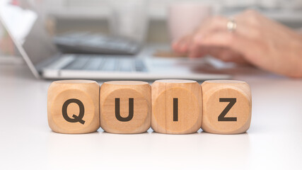 Engage in interactive quiz preparation using blocks and a laptop for efficient learning