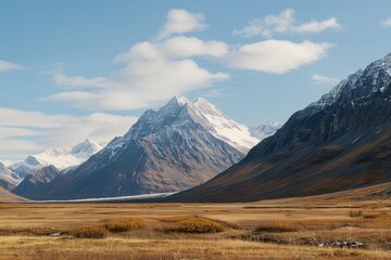 A majestic mountain range with snow-capped peaks in the distance, perfect for use in outdoor and nature-themed projects