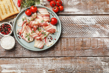 Slices of raw bacon, spices, bread and tomatoes on wooden table, flat lay. Space for text