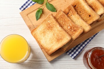 Delicious toasts served on wooden table, flat lay