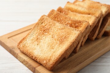 Delicious toasts on white wooden table, closeup