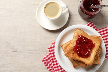 Delicious toasted bread slices served on wooden table, flat lay. Space for text