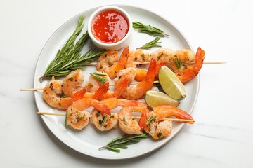 Skewers with delicious grilled shrimps served on white marble table, top view