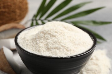 Coconut flour in bowl on table, closeup