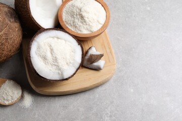 Coconut flour and fresh fruits on light grey table, above view. Space for text