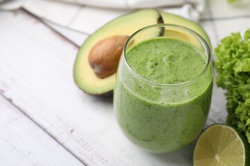 Tasty green smoothie in glass and products on wooden rustic table, closeup. Space for text