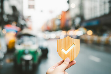 Businessman holding shield protect icon, Security protection and health insurance. The concept of family home, foster care, homeless support, protection, health care day and Travel insurance.