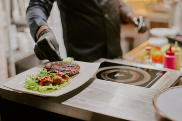 Medium close up of white rectangular plate with vegetable salad and black angus steak with golden crust