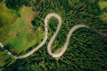 Aerial view of the road passing through the mountain and green forest. Curve asphalt road on mountain.	
