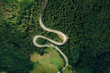 Aerial view of the road passing through the mountain and green forest. Curve asphalt road on mountain.	
