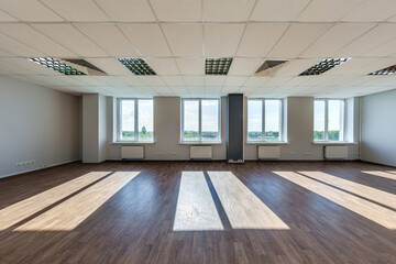 panorama view in empty modern office hall with sunlight in windows