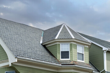 Gabled dormer on a steeply pitched roof of a family house in Brighton, Massachusetts, USA
