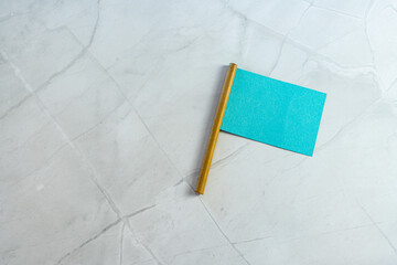 blue empty neutral miniature flag with empty copyspace as note on white marble background