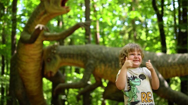 The boy watching Exhibition of moving models of sculpture dinosaur in Dinopark