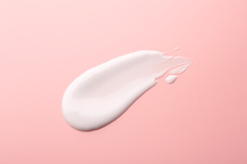 Sample of face cream on pink background, top view