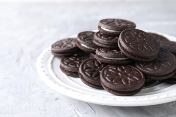 Many tasty sandwich cookies on light grey table