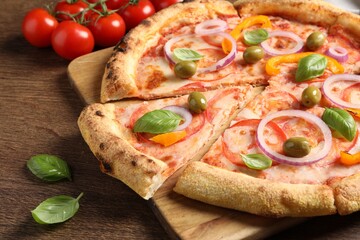 Cut delicious vegetarian pizza on wooden table, closeup
