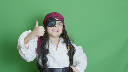 Halloween approval. Child in pirate costume showing thumb up. High quality photo
