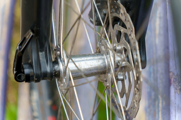 A modern mountain bike on the street. Brake disc and hub of a mountain bike in close-up.