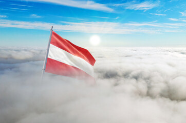 Naklejka premium Austria flag aerial view in beautiful sky with clouds. Top-down drone shot at sunrise or sunset. Aerial bird's eye view of the flag with cloudscape.
