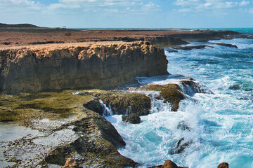 Huge waves breaking on spectacular cliffs, at Point Quobba, a remote part of the Western Australian Coral Coast south of Carnarvon 
