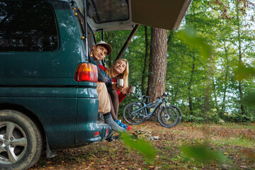 Young Couple Enjoying Tea in Scenic Van