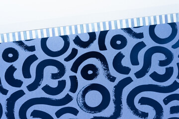 scrapbooking paper pad open to a contemporary pattern featuring thick line segment and stripe with short lines