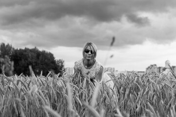 Portrait of a beautiful blonde girl outdoors. Black and white photo.