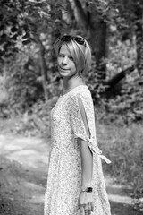 Portrait of a beautiful blonde girl outdoors. Black and white photo.