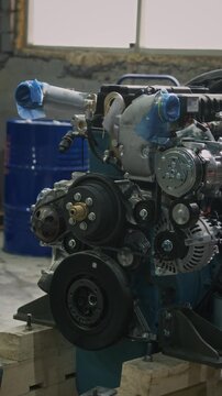 No people vertical shot of tractor large internal combustion engine with sheaves and pulleys in heavy machinery production plant