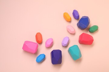 Many colorful balancing stones on beige background, top view