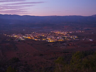 Adzaneta del Maestre, a village in El Maestrazgo, in the Province of Castellón, Spain, illuminated at night, from the mountains of El Bovalar