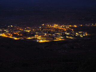 Adzaneta del Maestre, a village in El Maestrazgo, in the Province of Castellón, Spain, illuminated at night, from the mountains of El Bovalar